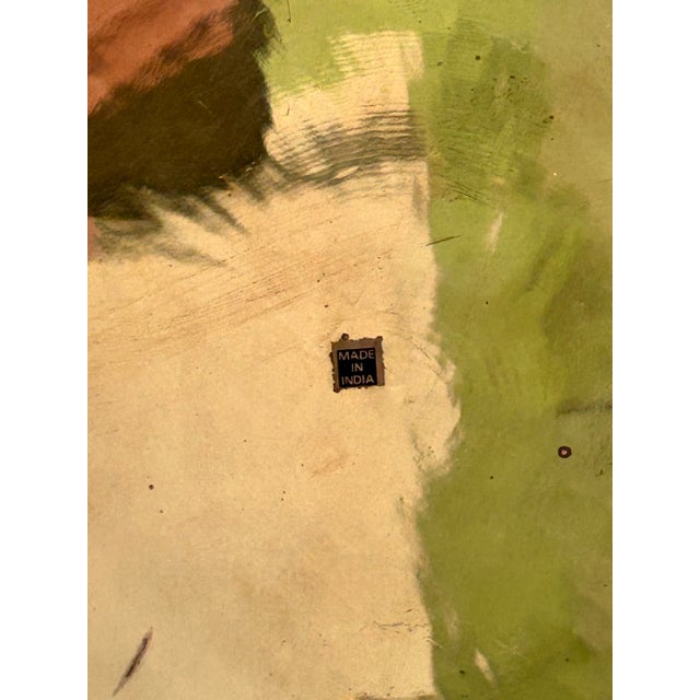 This vintage brass serving tray features a round form, reflective surface, and ornate filigree border with Moorish-...