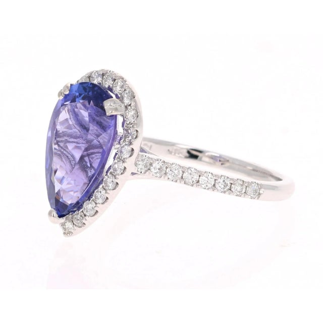 This ring has a electrifying Pear Cut bright purplish blue Tanzanite weighing 3.73 Carats. The traditional halo setting...