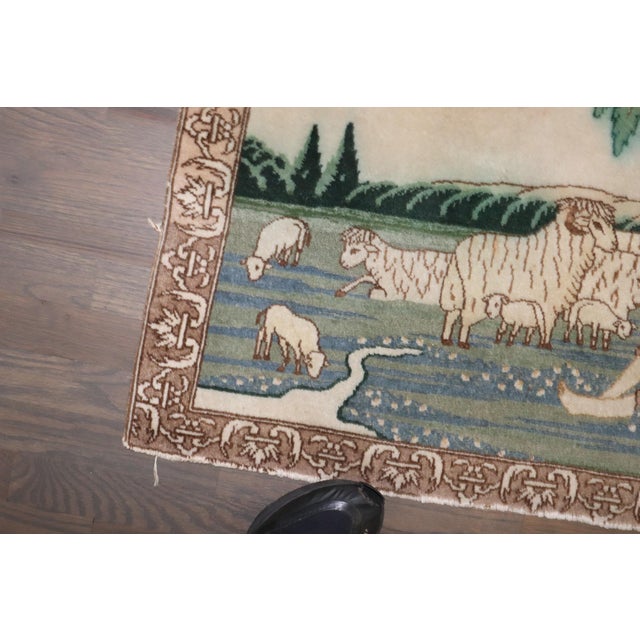 A mid 20th century Persian Tabriz small rug with a man lying on the ground surrounded by a flock of sheep