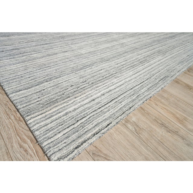 The Rossini rug was designed to ground any room with its lush softness, rich dimensional texture and striated design. Made...