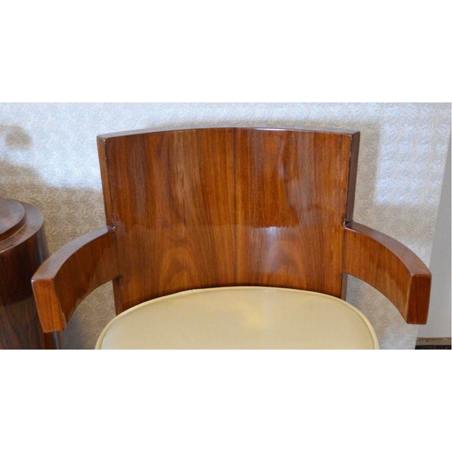 Mid-Century Art Deco armchair with concave backrest, armrests and rear leg and off-white leather covered seat cushion....