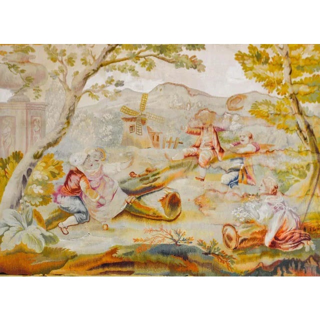 A wonderful mid 19th century French Aubusson tapestry depicting several children in period clothing playing on a log...