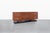 This custom-built mid-century modern credenza offers a refined balance of clean lines, warm wood tones, and functional...
