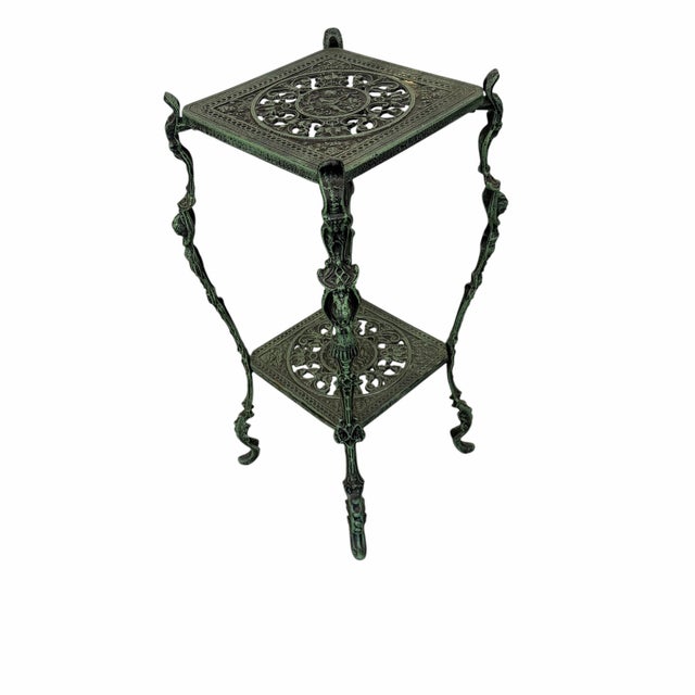 Vintage tiered cast metal plant stand, styled with ornate Victorian or Renaissance-style filigree and "figural" legs....