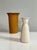 Beautiful pair of hand-thrown vases in rust red and cream white. Larger vase, a cylindrical shape widening towards the top...