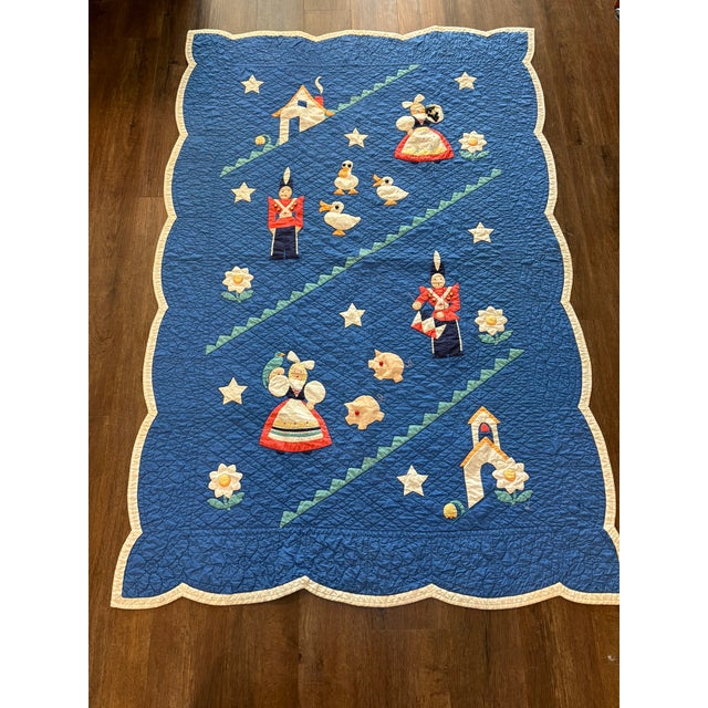 Charming handmade child’s quilt featuring Dutch dancers, toy soldiers, ducks, pigs, cottages, flowers, and stars appliquéd...