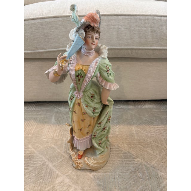 Pair of 19th Century German Porcelain figurines depicting a courtly couple in elaborate Rococo style attire. Primary...