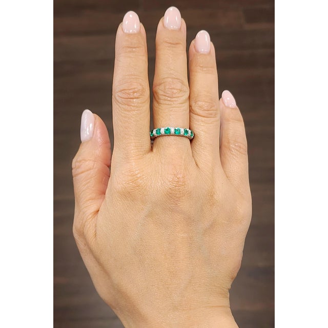Beautiful natural emerald and diamond eternity band. The band features 14 round brilliant emeralds weighing 1.58 ct and...