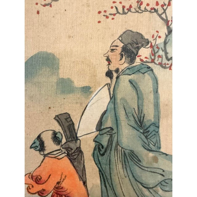 Delicate hand-painted Chinese artwork depicting a scholar accompanied by an attendant beneath a flowering tree, rendered...