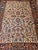 "This exceptional early 20th-century Persian Heriz rug has an extremely rare and highly desired ivory color background in...