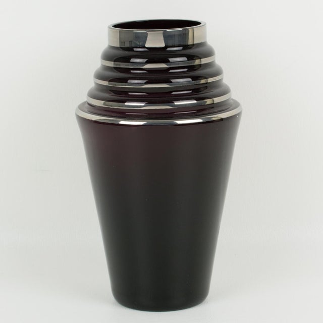 This lovely 1930s French Art Deco black glass vase features a silver deposit decoration all around with geometric...