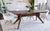A gorgeous handcrafted dining table in solid American black walnut, made by Moderncre8ve in Ohio. The sculptural splayed-...