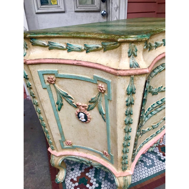 A commode in transitional from rococo to neoclassical style . Presents well and has strong presence with pastels of pink...