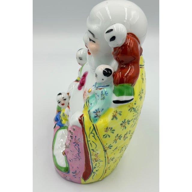 Chinese famille rose porcelain and poly-chrome enamel Hotei Laughing Buddha figure with five boys, probably dating from...