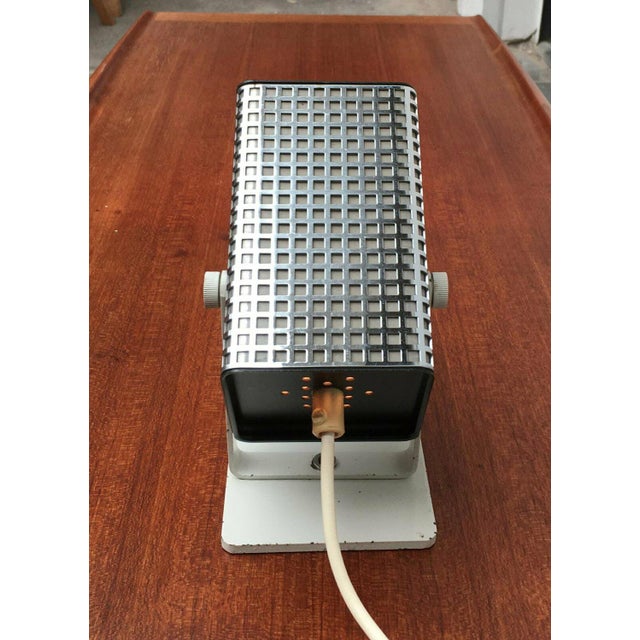 Mid-century table lamp in spotlight shape. The special feature of this heavy spotlight lies in the casing made of chrome-...