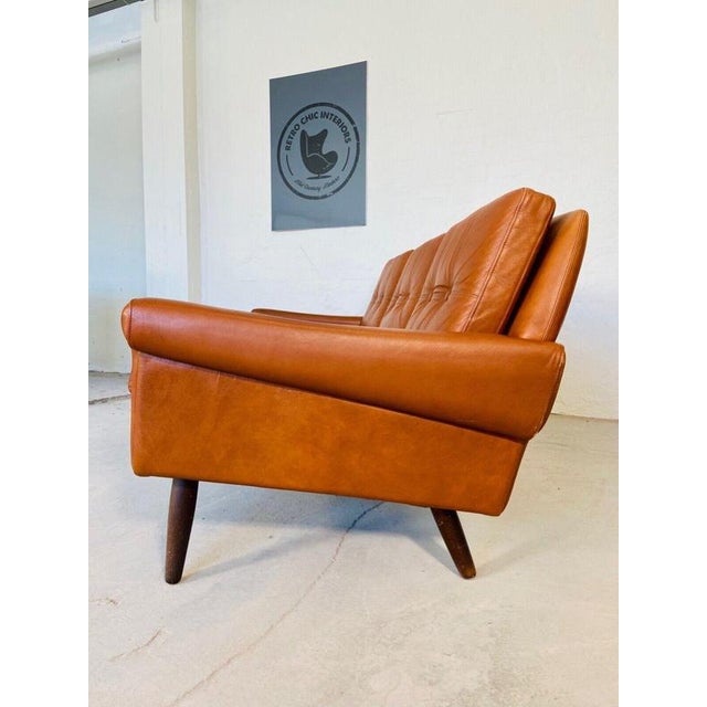 The sofa set characterized by its clean and minimalist design, embodying the essence of mid-century modern aesthetics. The...