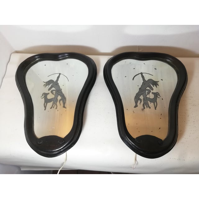 Beautiful and distinctive pair of backlit and decorated wall mirrors. Black aniline-finished hardwood frames. Original...