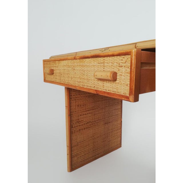 A Vintage Writing desk with drawers made in Italy between the 1960s and the 1970s. This writing desk has a solid structure...