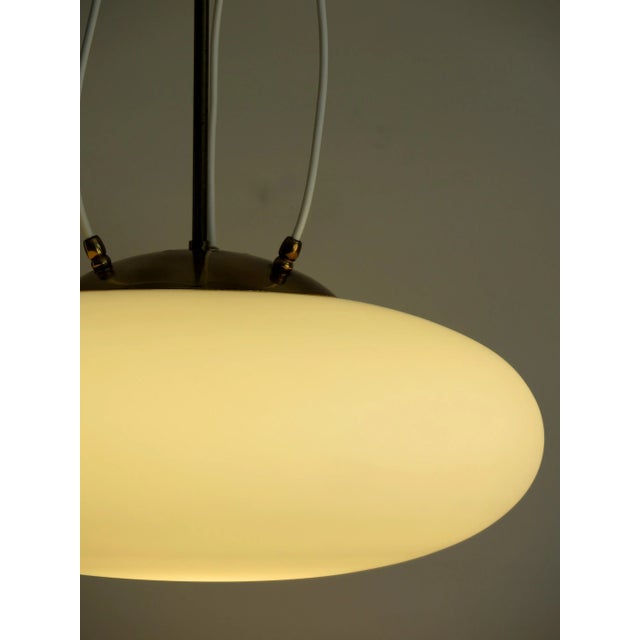 Chandelier 1104 model (variant) produced by Stilnovo, diffuser curved white frosted glass and stem in brass, 1950. This...