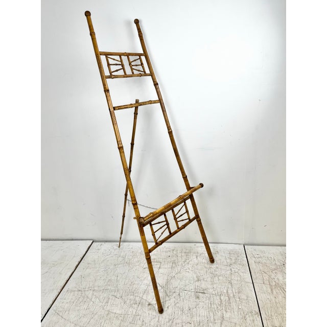 Antique burnt bamboo easel display. Burnt bamboo frame with fretwork details. Adjustable chain. Folds up for easy storage....