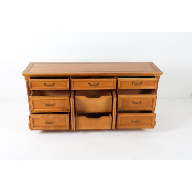 This dresser was made by Stanley Furniture and brass accents and hardware. It has what looks to be maple and walnut accent...