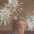 This unique artwork features a Cereus flower in a pot, crafted through a creative collage of layered fabric and paint. The...