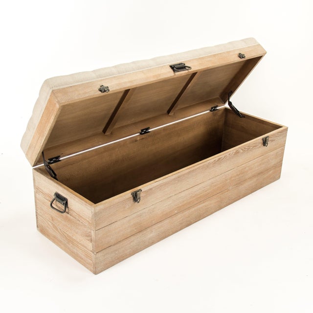 The Stockage Bench from Zentique is a handsome storage trunk with a button-tufted natural linen top that lifts to reveal...