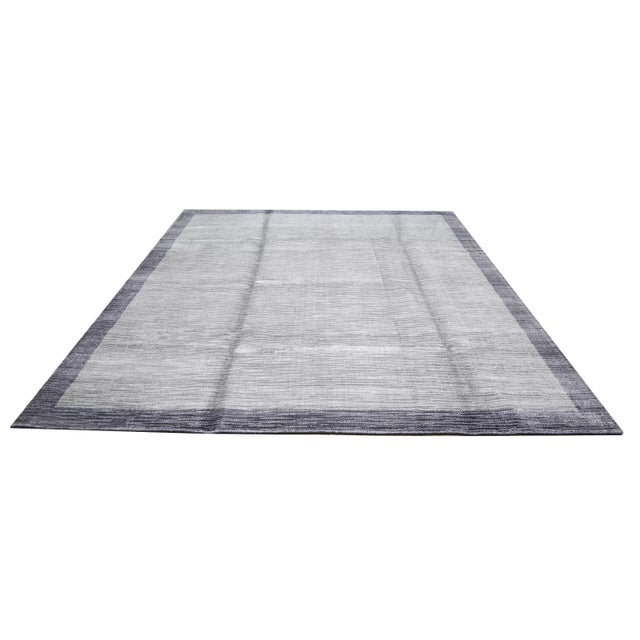 Modern silk hand knotted rug with natural colors and fine weave.