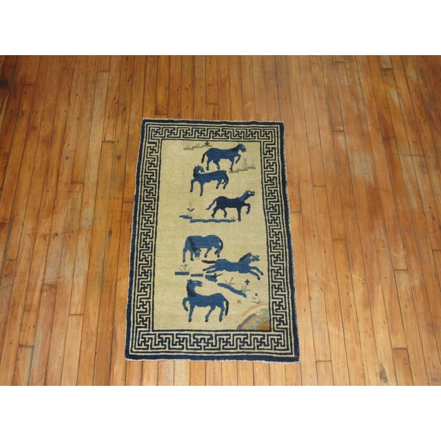 An early 20th century Chinese pictorial horses rug. Six blue horses flocking on a ivory colored ground. 2'2" x 3'9"
