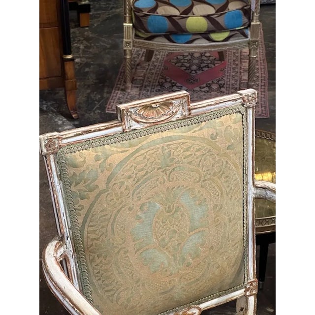 Gorgeous and rare carved and painted Neo-Classical style chair. Upholstered in 1958 in Fortuny. An exceptional piece!!