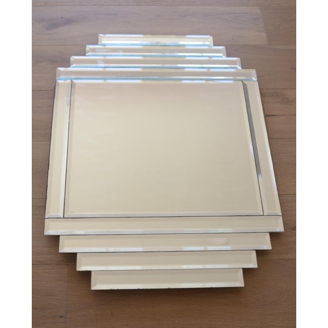 Beautiful vintage wall mirror from the Art Deco revival period of the 1970s. Mirror has 10 elongated beveled pieces of...