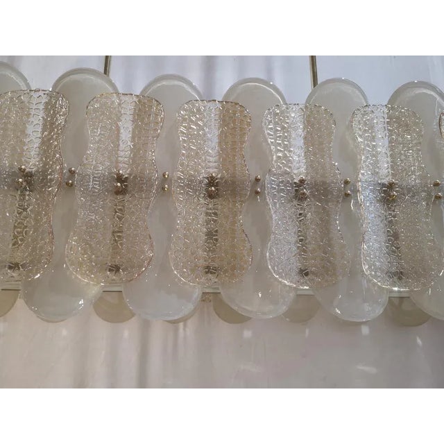 Murano chandelier with an elongated design with a brass structure and unique glass champagne color and sandblasted. All in...