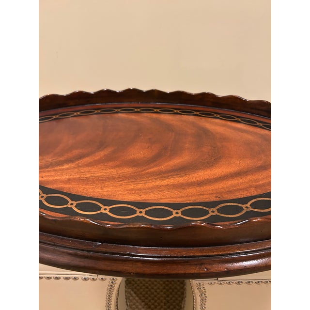 Stunning oval mahogany serving tray having pie crust edge and chain link inlaid design.