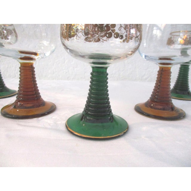Lovely mid-century set of five Roemer wine glasses with beehive design stems. Set consists of two amber-shaded stems with...