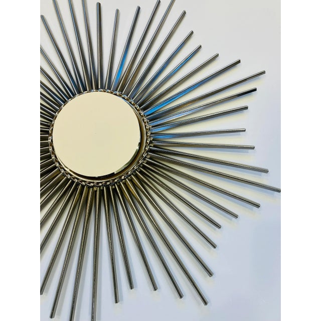 This silver tone mirror has a convex glass mirror in the center 24 inch diameter We have seen many gold tone mirrors in...
