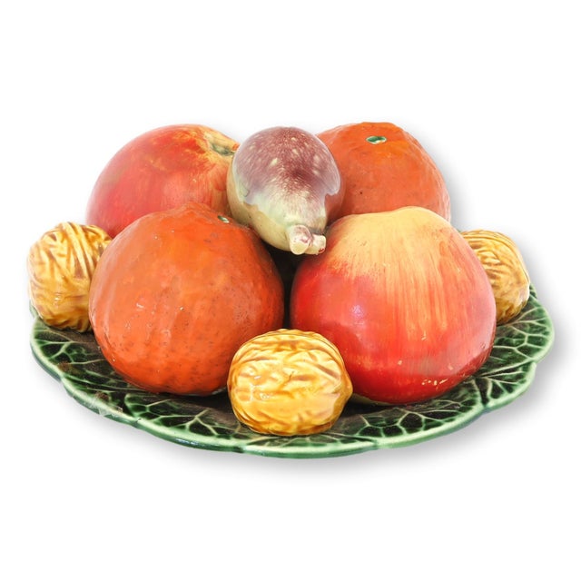 French majolica trompe-l’oeil fruit plate featuring a lively arrangement of hand-modeled fruit, including oranges, apples,...