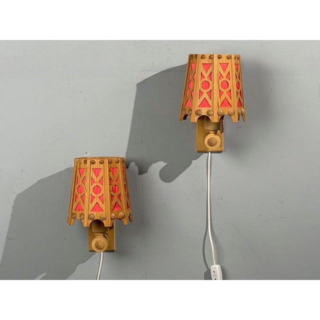 Swedish Mid-Century Modern, Wall Lights or Sconces, Pine, Red Textile, Sweden, 1970s Interesting pair of carved pine and...
