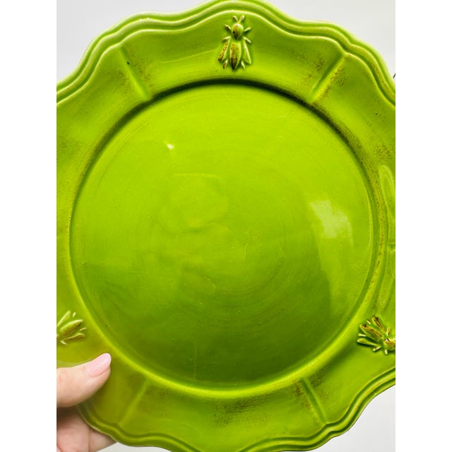 This is a set of six lime green ceramic dinner plates by Faianças Neto & Gomes, Lda, a Portuguese pottery studio known for...