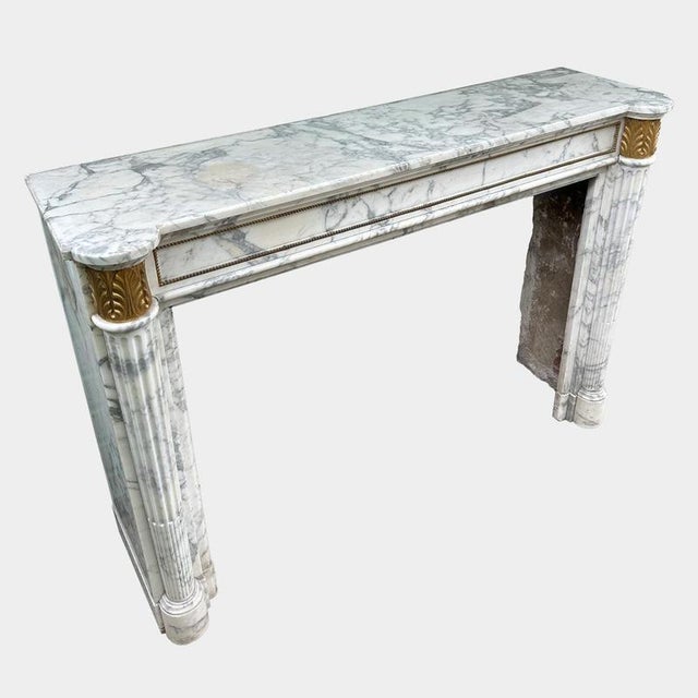 An antique circa 1850 Louis XVI style Arabescato marble fireplace with Ormolu capitals and beaded freize. Unusually large...