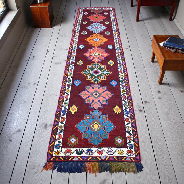 This hand-knotted runner rug, hailing from the rugged landscapes of Southeastern Anatolia, represents a vibrant chapter of...