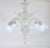 This small and dazzling handcrafted opaline Murano chandelier has four flexing arms with prominent tri-lobed cups. The...
