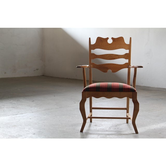 An example of mid-century Danish design, this single Henning Kjærnulf brutalist oak armchair embodies the designer's...