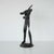 Vintage circa 1990s forged iron figure of a man with his arms in a wrapped position. Crafted from a single piece of iron...