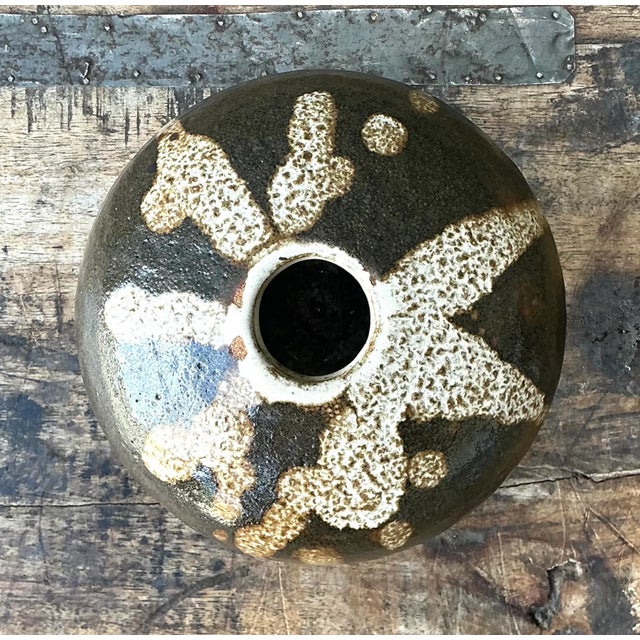 This vintage ceramic vessel is a striking example of mid-20th-century studio pottery, its compact form defined by a...