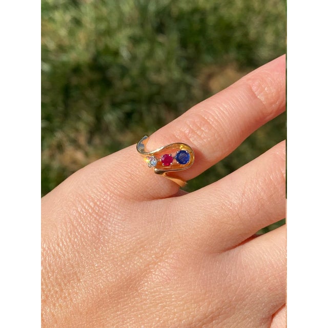 The Tegan Ladies Contemporary Patriotic Ring set in 14K Yellow Gold. This ring is crafted in 14 karat yellow gold and...