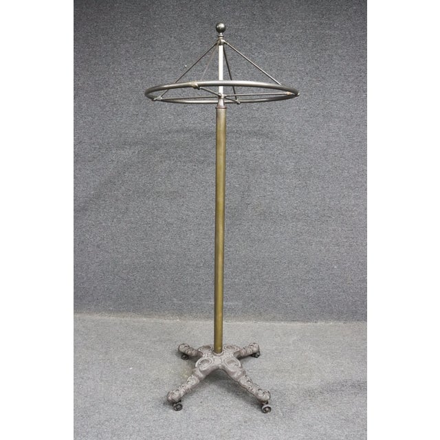 Victorian cast iron and brass rounder garment rack with ornate base. *Rotating top