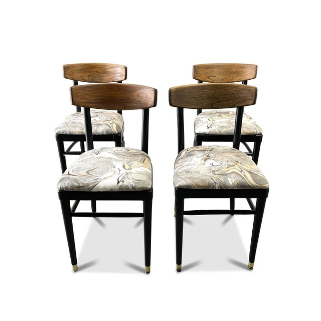 A set of four Thonet bentwood dining chairs that have been fully restored. The vintage bistro chairs feature a walnut...