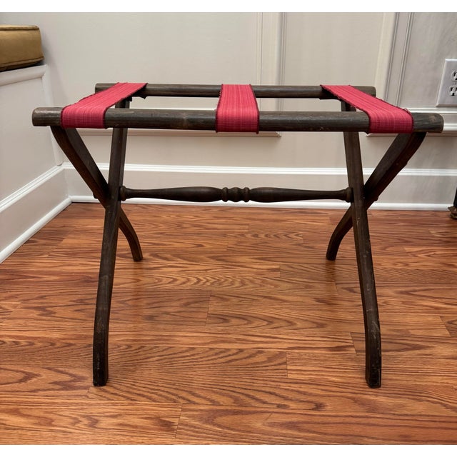 This collapsible luggage rack gives a nod to cabin, Adirondack decor style. Consisting of three two inch wide red canvas...