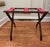 This collapsible luggage rack gives a nod to cabin, Adirondack decor style. Consisting of three two inch wide red canvas...