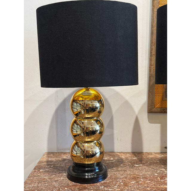 Pair of vintage stacked ball table lamp in brass with black linen and gold interior lining. In the style of George Kovacs....